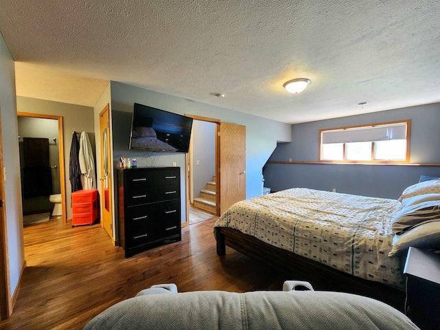 12902 Flicker Rd, Tomah, WI 54660 - bedroom featuring wood finished floors and a textured ceiling