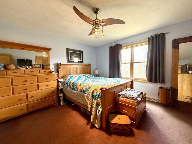 bedroom featuring ceiling fan and dark colored carpet