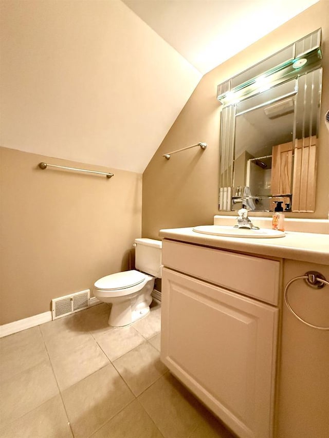 bathroom with toilet, vaulted ceiling, visible vents, tile patterned flooring, and vanity