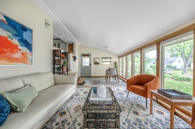 1301 Temkin Ave, Madison, WI 53705 - living room featuring vaulted ceiling, wood finished floors, and baseboards