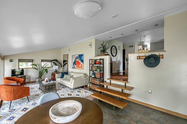 1301 Temkin Ave, Madison, WI 53705 - living room featuring baseboards, stone finish flooring, and lofted ceiling