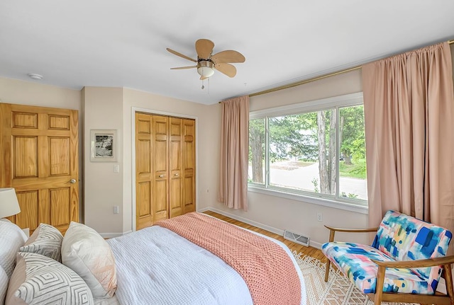 1301 Temkin Ave, Madison, WI 53705 - bedroom featuring baseboards, a closet, wood finished floors, and a ceiling fan
