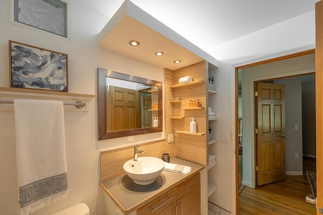 1301 Temkin Ave, Madison, WI 53705 - bathroom with vanity, wood finished floors, recessed lighting, toilet, and baseboards