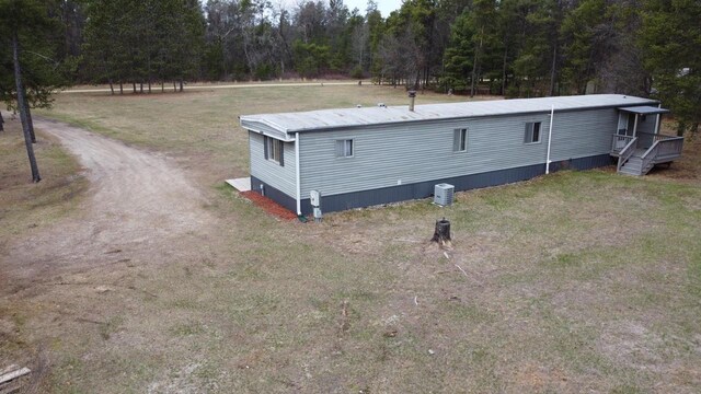 N9140 Snow Snake Trl, Necedah, WI 54646 - exterior space with a forest view, a wooden deck, and a yard