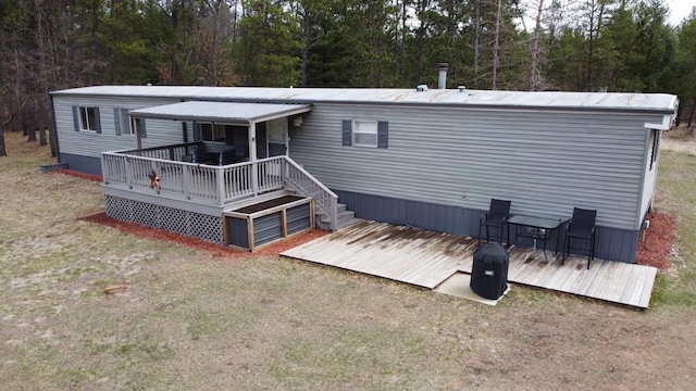 N9140 Snow Snake Trl, Necedah, WI 54646 - rear view of house with a wooden deck and a wooded view