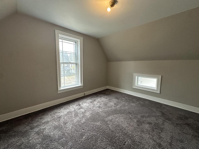 3313 W Kilbourn Ave, Milwaukee, WI 53208 - additional living space with dark carpet, vaulted ceiling, and baseboards