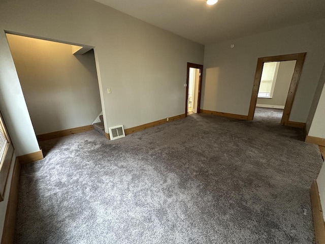 3313 W Kilbourn Ave, Milwaukee, WI 53208 - empty room featuring stairway, baseboards, visible vents, and carpet