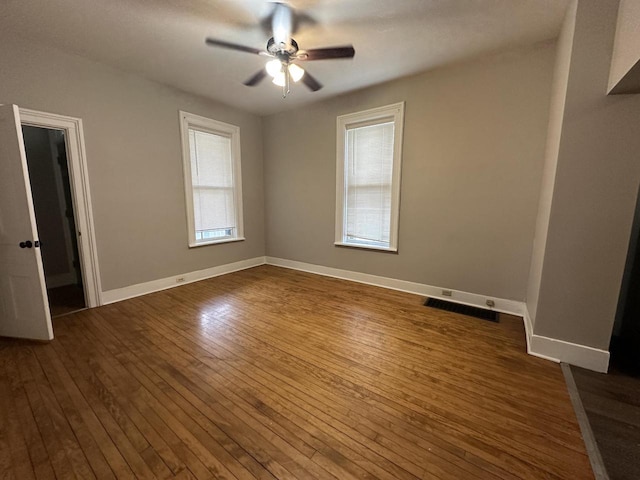 3313 W Kilbourn Ave, Milwaukee, WI 53208 - unfurnished bedroom featuring baseboards, visible vents, a ceiling fan, and dark wood-style floors