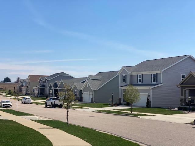 view of street featuring a residential view, sidewalks, and curbs