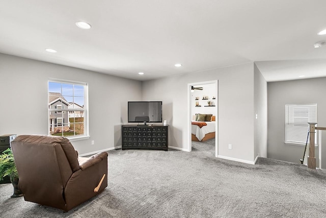 carpeted living area featuring recessed lighting and baseboards