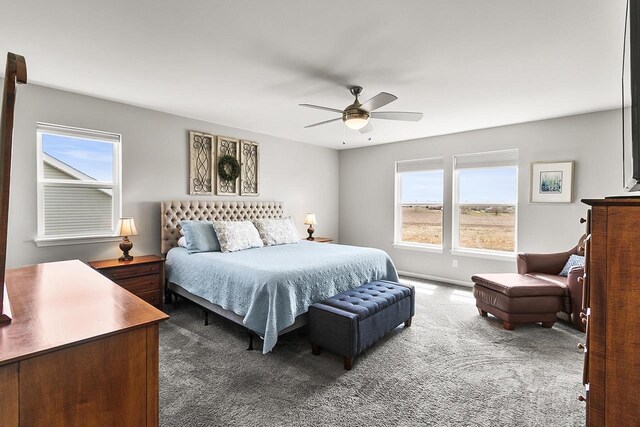 bedroom with ceiling fan, carpet flooring, and multiple windows