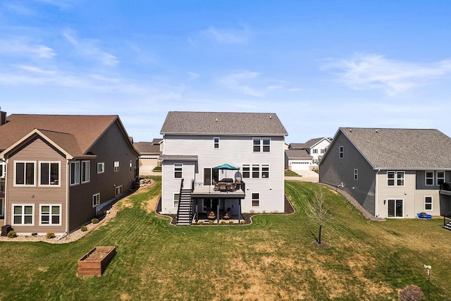 rear view of property featuring stairway, a wooden deck, a lawn, and a residential view