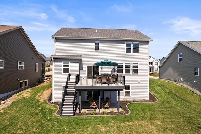 back of house with a wooden deck, stairway, a yard, and a patio