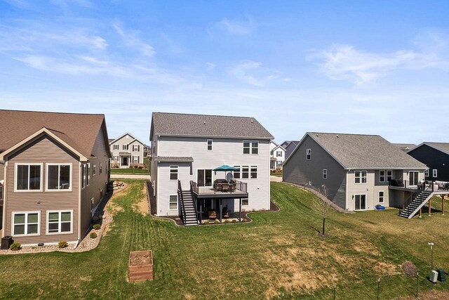 rear view of house featuring a wooden deck, stairway, and a residential view