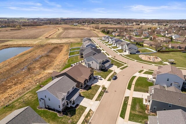 drone / aerial view with a residential view and a water view