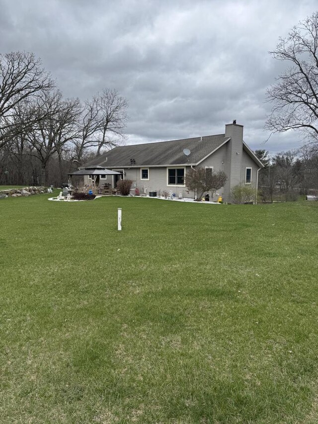 W360S10139 Markham Rd, Eagle, WI 53119 - view of front of home featuring a chimney and a front yard