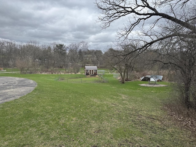 W360S10139 Markham Rd, Eagle, WI 53119 - view of yard featuring an outbuilding, a shed, and fence