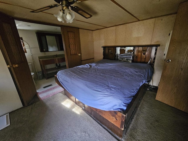 carpeted bedroom with ceiling fan and visible vents