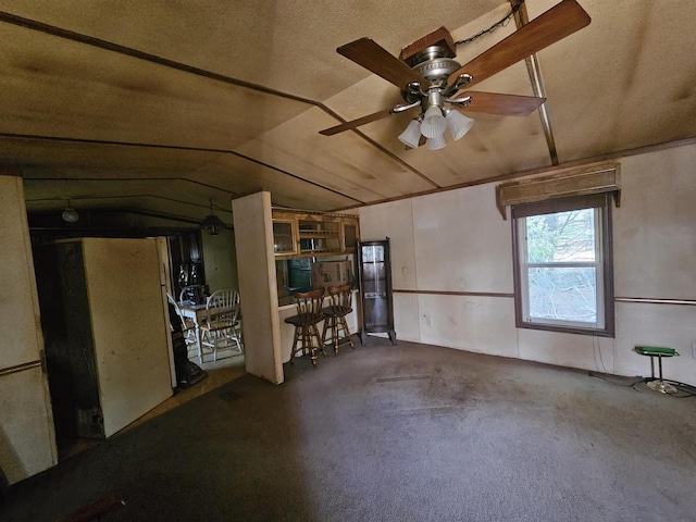 unfurnished room featuring vaulted ceiling, carpet floors, and a ceiling fan