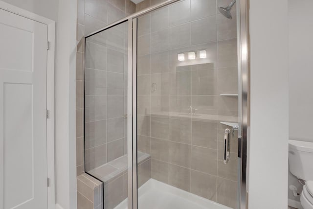full bathroom with a shower stall and toilet