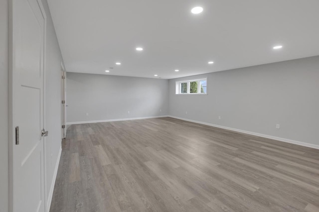 below grade area featuring recessed lighting, light wood-style floors, and baseboards
