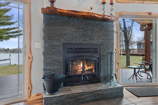 905 Plymouth Ct, Nekoosa, WI 54457 - interior details featuring a glass covered fireplace, wood finished floors, and a water view