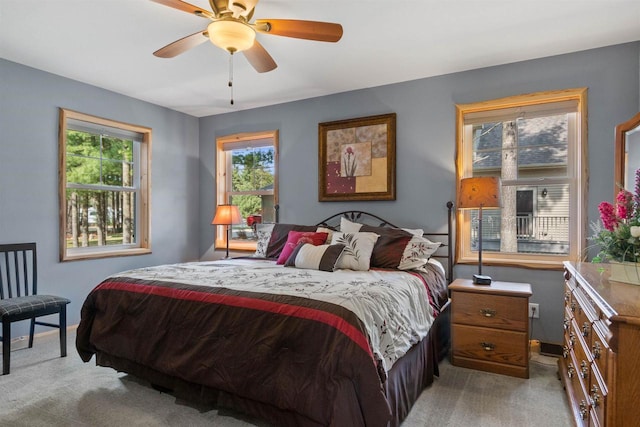905 Plymouth Ct, Nekoosa, WI 54457 - bedroom featuring light carpet, a ceiling fan, multiple windows, and baseboards