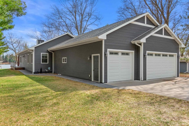 905 Plymouth Ct, Nekoosa, WI 54457 - view of side of property with a lawn, driveway, and a garage