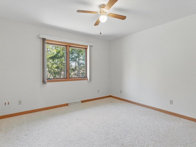 W7436 County Road V, Cascade, WI 53011 - unfurnished room featuring ceiling fan, baseboards, carpet flooring, and visible vents