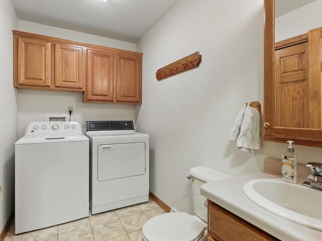 W7436 County Road V, Cascade, WI 53011 - laundry room with washing machine and clothes dryer, baseboards, a sink, and light tile patterned flooring