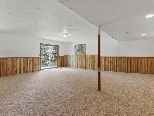 W7436 County Road V, Cascade, WI 53011 - basement with a wainscoted wall, carpet flooring, wooden walls, and recessed lighting