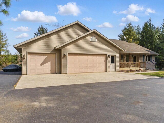 W7436 County Road V, Cascade, WI 53011 - ranch-style house with a garage, driveway, and a porch