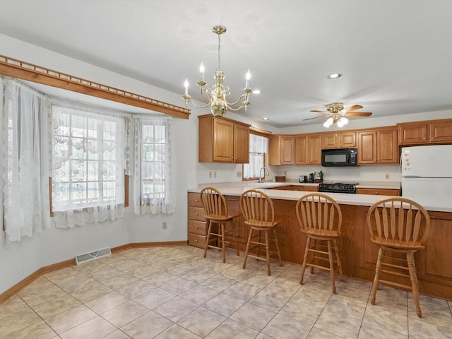 W7436 County Road V, Cascade, WI 53011 - kitchen featuring a sink, black appliances, light countertops, baseboards, and visible vents