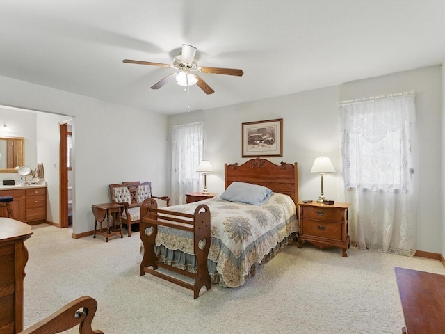 W7436 County Road V, Cascade, WI 53011 - bedroom with ensuite bath, ceiling fan, light carpet, and baseboards