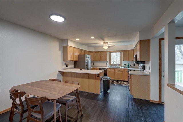 25 Cherbourg Ct, Madison, WI 53711 - kitchen with appliances with stainless steel finishes, a peninsula, dark wood finished floors, light countertops, and recessed lighting