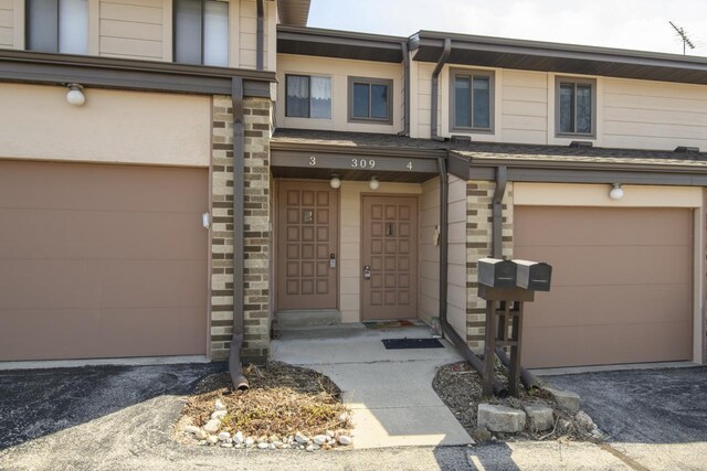 property entrance featuring an attached garage