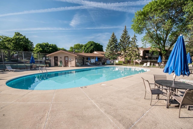 pool featuring a patio and fence