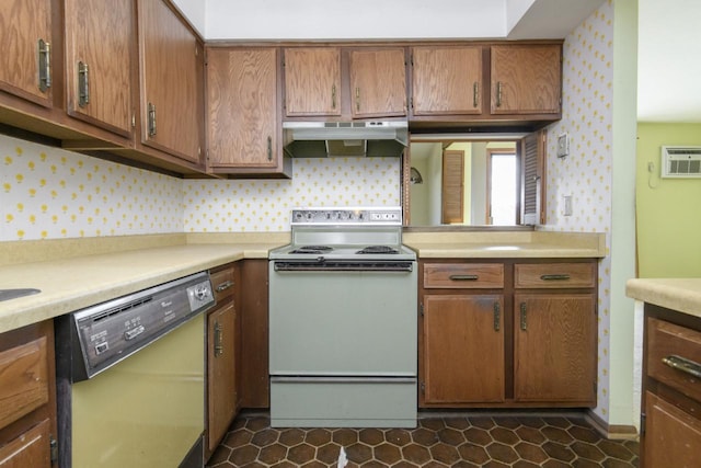 kitchen with under cabinet range hood, light countertops, dishwashing machine, and white electric range