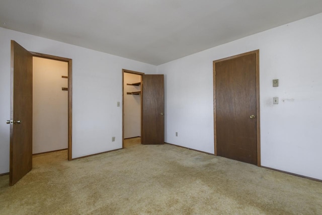 unfurnished bedroom featuring baseboards and carpet