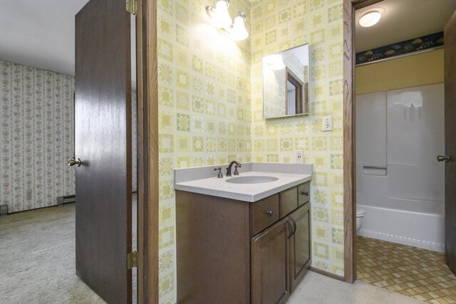 full bath featuring wallpapered walls, vanity, and toilet