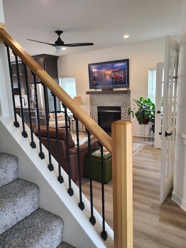 2034 N 13th St, Milwaukee, WI 53205 - stairs featuring baseboards, recessed lighting, wood finished floors, ceiling fan, and a fireplace