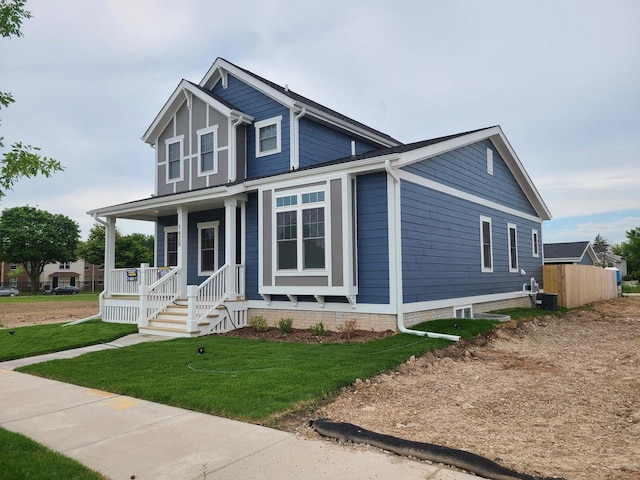 2034 N 13th St, Milwaukee, WI 53205 - craftsman-style house with a porch, a front yard, and central air condition unit