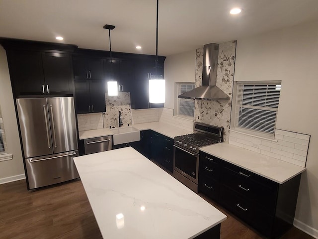 2034 N 13th St, Milwaukee, WI 53205 - kitchen featuring dark cabinets, stainless steel appliances, a sink, and wall chimney range hood