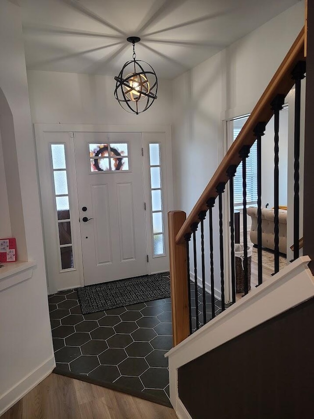 2034 N 13th St, Milwaukee, WI 53205 - foyer entrance with wood finished floors, baseboards, a chandelier, and stairs