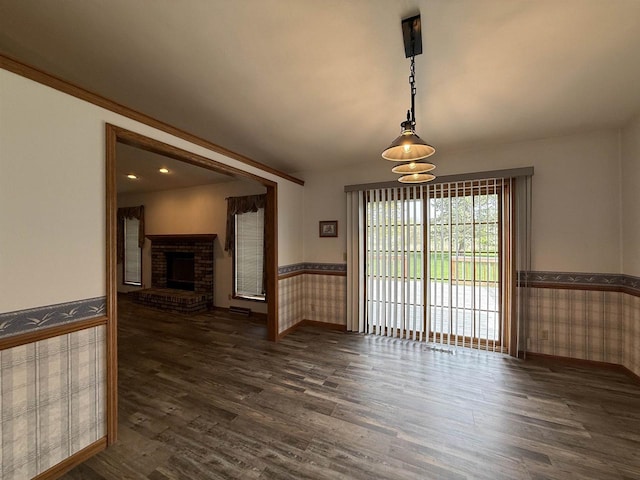 interior space featuring dark wood-type flooring, wainscoting, baseboards, and wallpapered walls