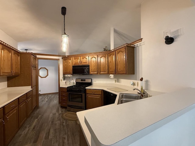 kitchen with dark wood-style flooring, a peninsula, light countertops, a sink, and black appliances