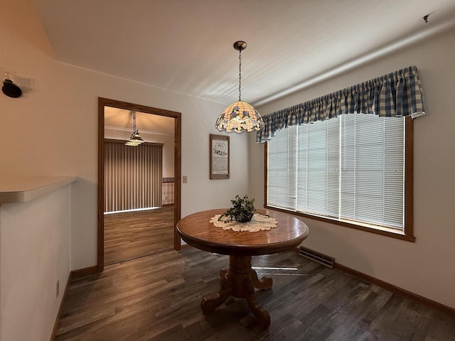 dining area with baseboards, wood finished floors, and visible vents