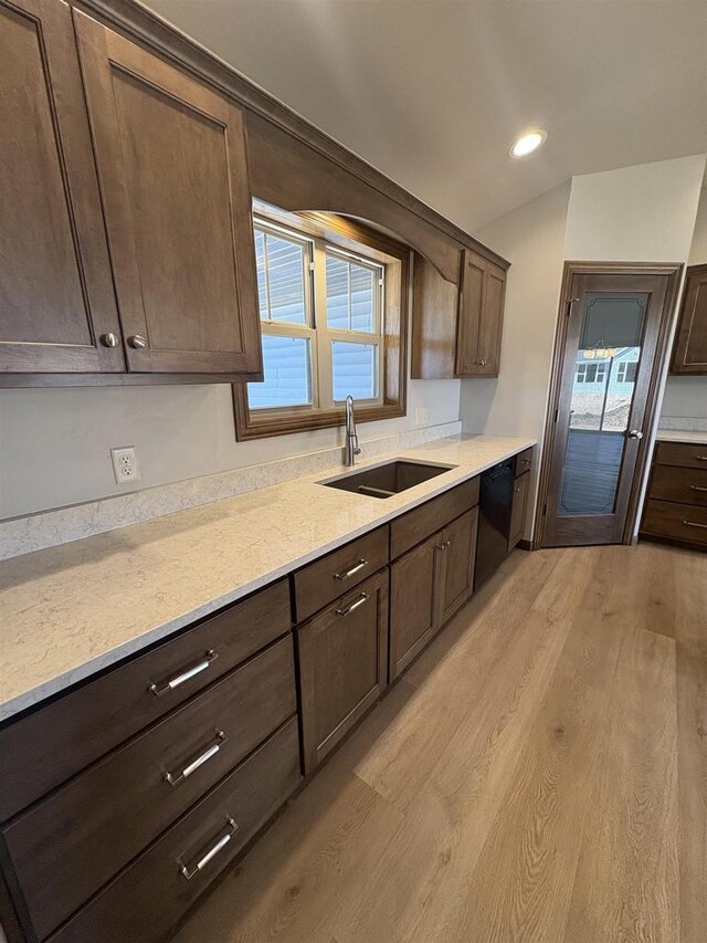 1354 Shelby Ln, De Pere, WI 54115 - kitchen with light wood-type flooring, dark brown cabinets, dishwasher, and a sink
