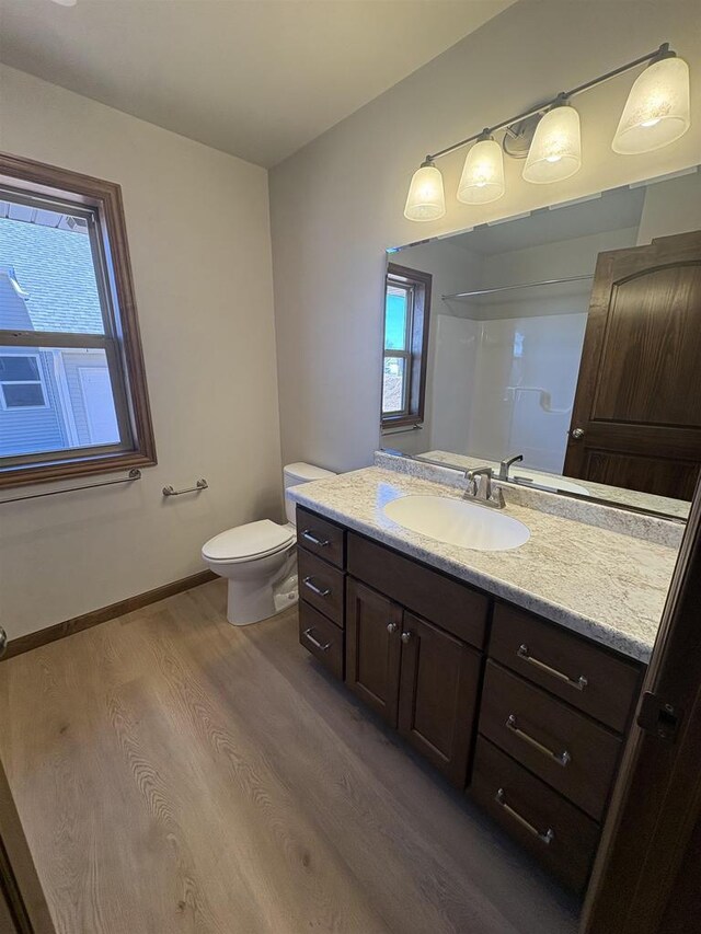 1354 Shelby Ln, De Pere, WI 54115 - bathroom with baseboards, wood finished floors, vanity, and toilet