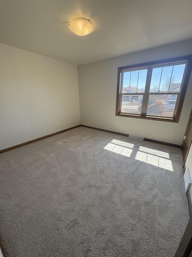 1354 Shelby Ln, De Pere, WI 54115 - empty room with baseboards, visible vents, and carpet floors